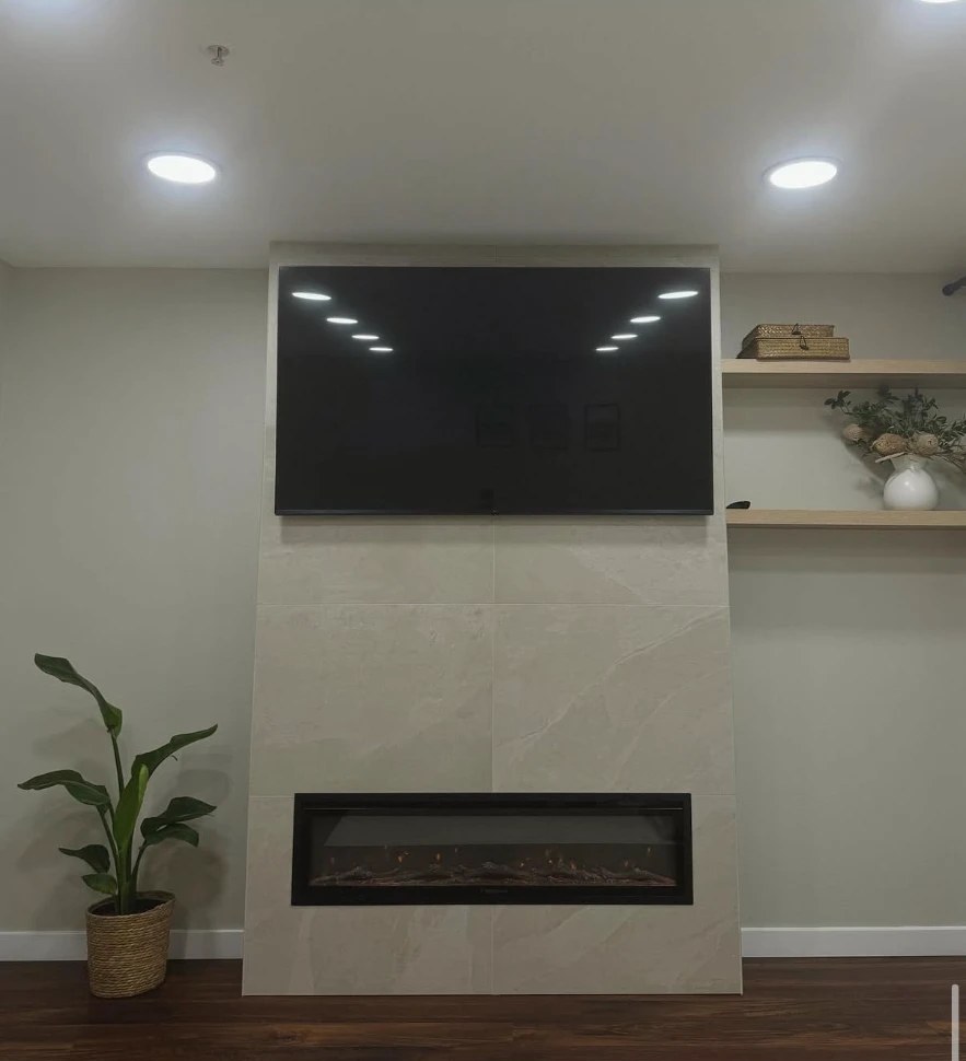 Large-format tile fireplace feature wall with mounted TV