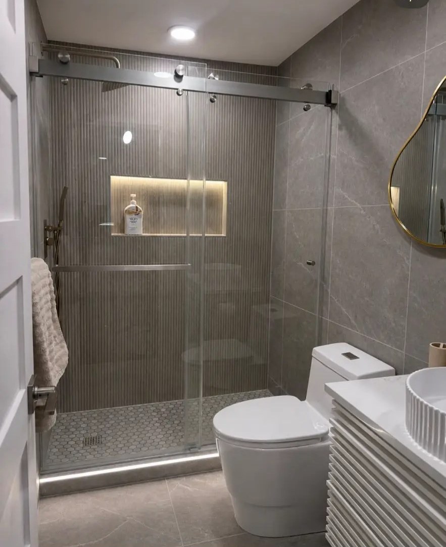 Completed bathroom remodel with fluted tile shower and floating vanity
