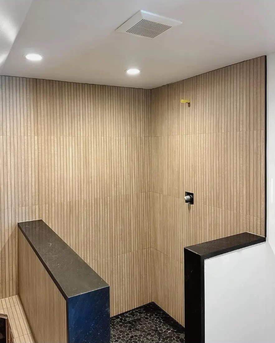 Vertical wood-look tile shower installed by BV Construction